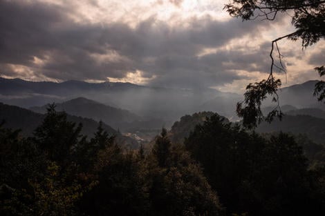 Looking out from Meki Tōge with sunlight spilling out from a post-rain cloudy sky.