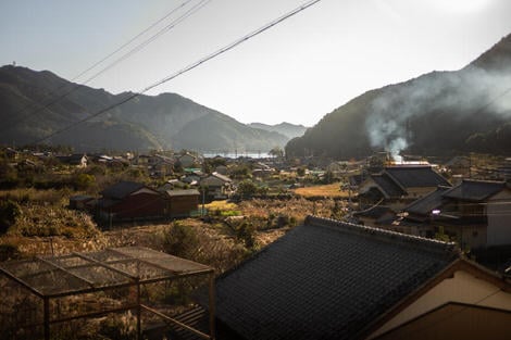 Looking down over Mikisato from the vantage of the train station, small houses with generous yards, smoking billowing from yard fires burning post-harvest refuse, the hint of the ocean in the background. 